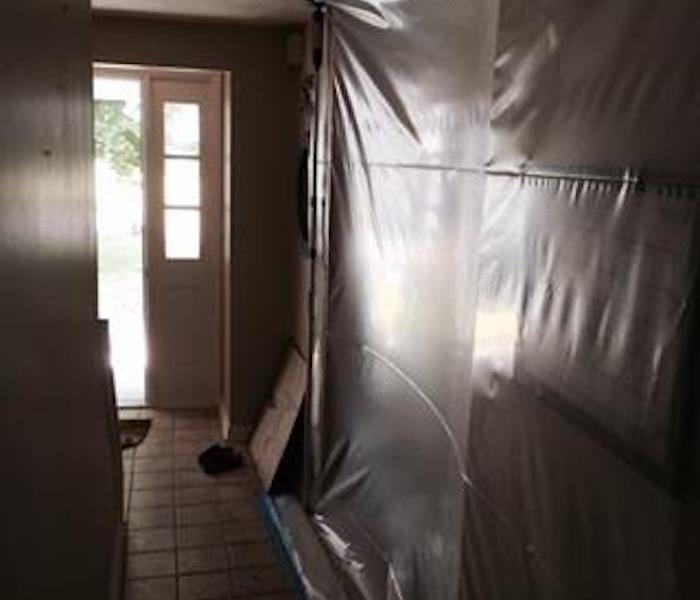homes entryway with plastic sheeting hung