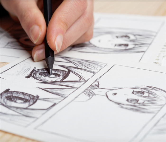 a person drawing a character on a comic strip